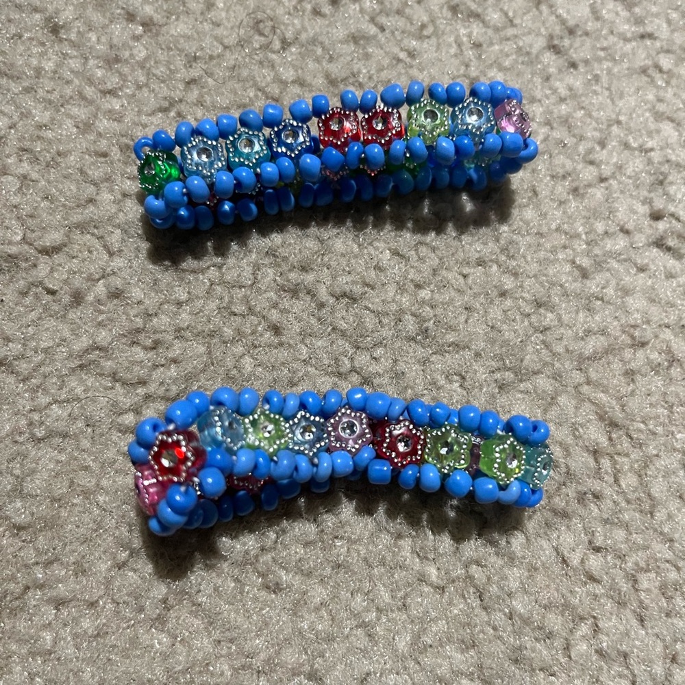 Two bracelets with multicolored gems interior and light blue embroidery